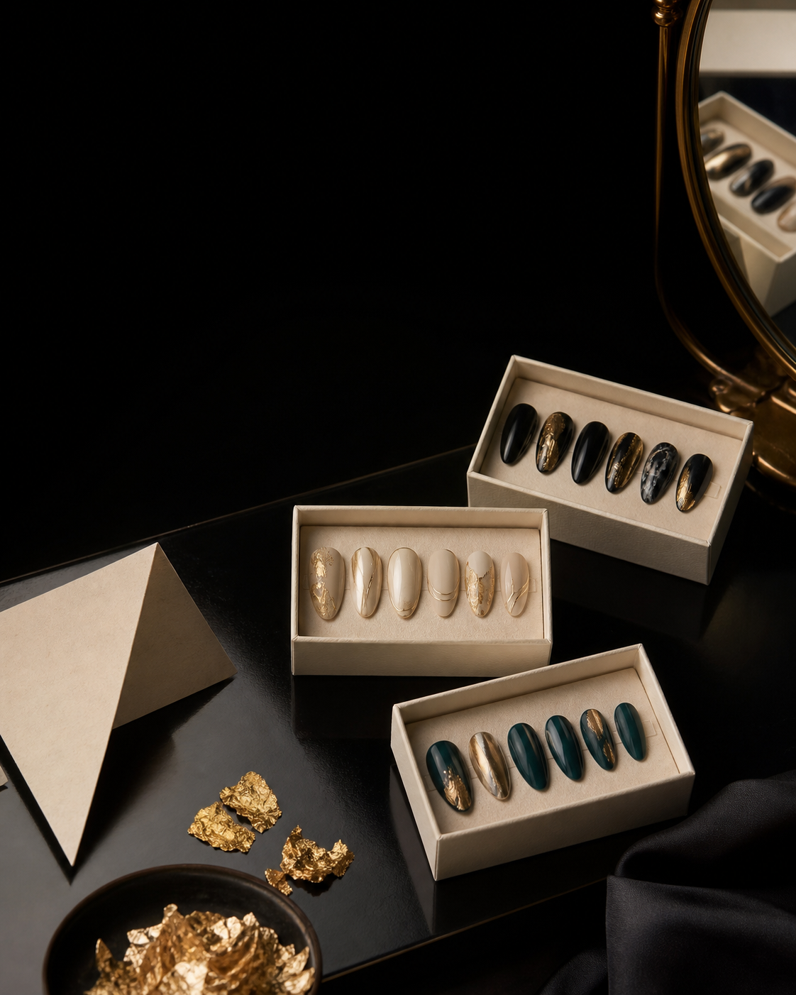 Press-on nail set concepts in ivory boxes with black, gold, and teal details